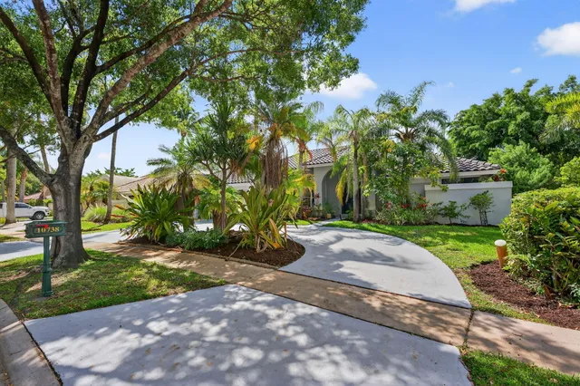 a living room with furniture and a large window with wooden floor