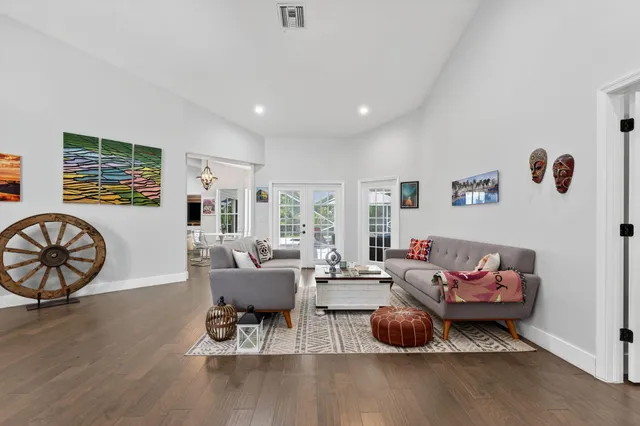 a bedroom with a bed and a large mirror on the dresser