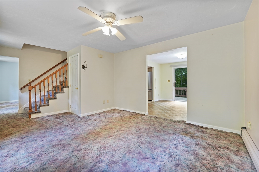 24 Springwood Drive Rochester, MA 02770 - Photo 13 of 21 a view of an empty room with stairs and a chandelier fan