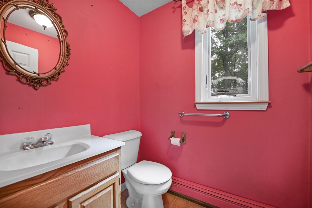 24 Springwood Drive Rochester, MA 02770 - Photo 14 of 21 a bathroom with a toilet a sink and mirror