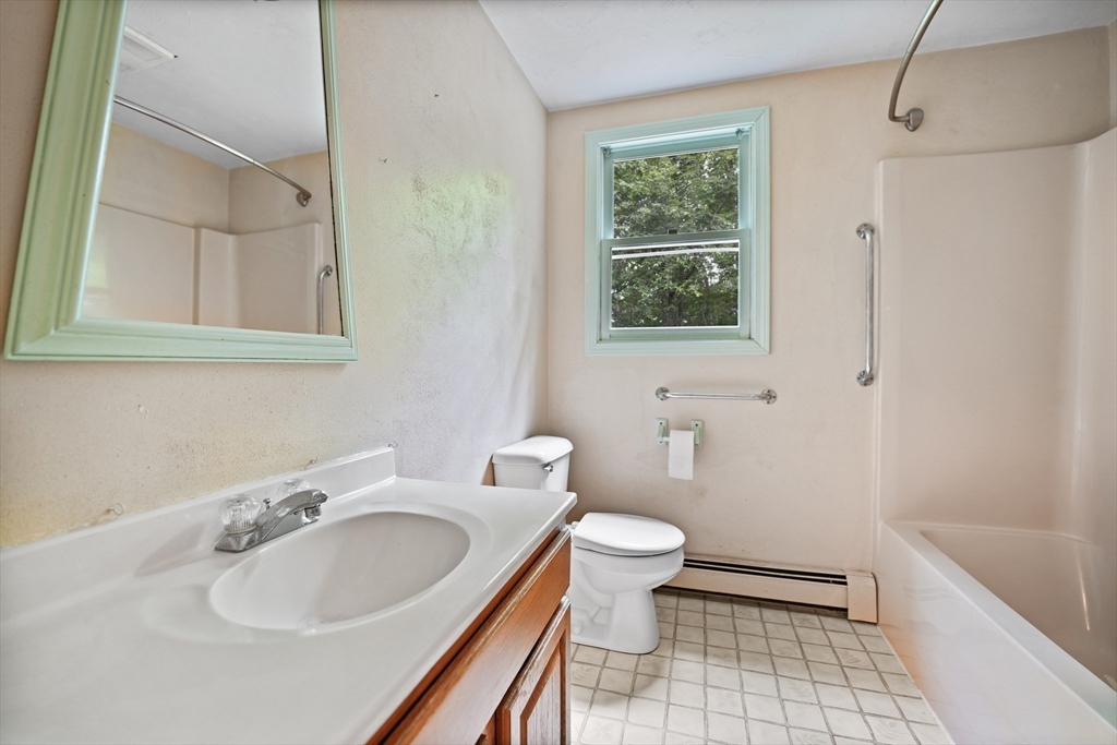 24 Springwood Drive Rochester, MA 02770 - Photo 18 of 21 a bathroom with a sink a toilet and a bathtub