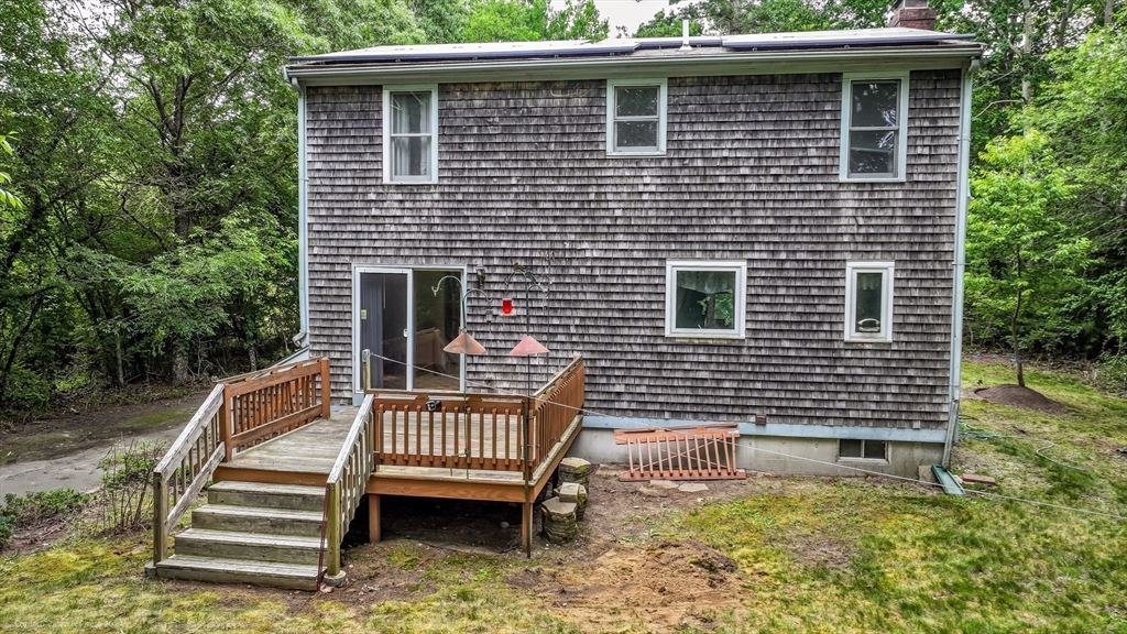 24 Springwood Drive Rochester, MA 02770 - Photo 20 of 21 a side view of a house with a yard