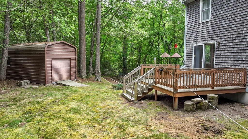 24 Springwood Drive Rochester, MA 02770 - Photo 21 of 21 a view of a wooden deck with chairs and a yard