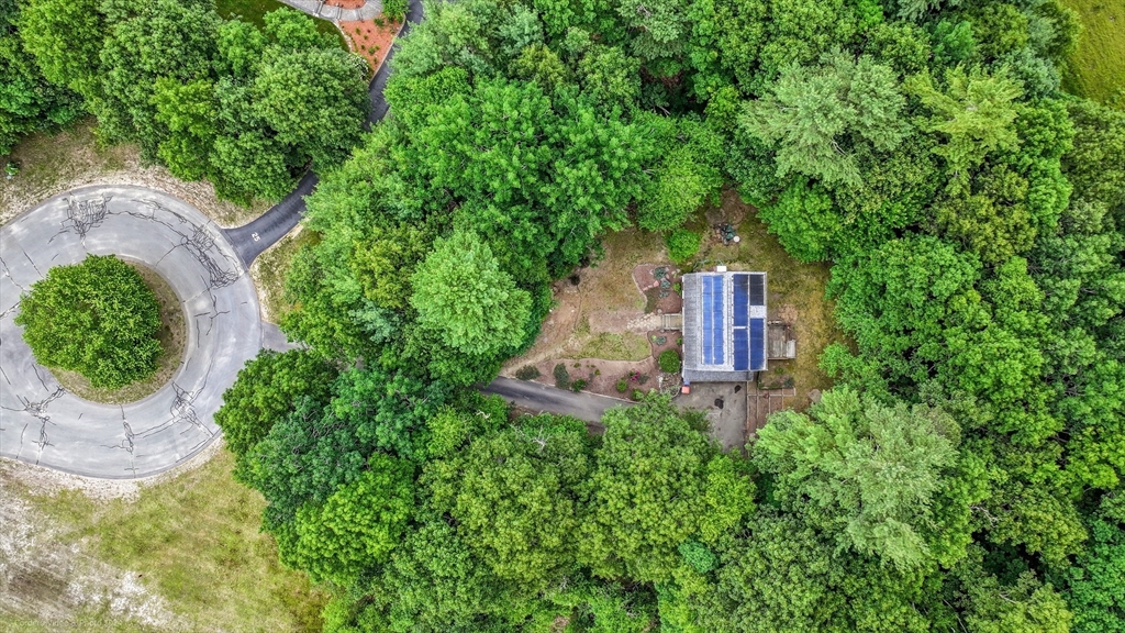 24 Springwood Drive Rochester, MA 02770 - Photo 3 of 21 an aerial view of a house with a yard and trees all around