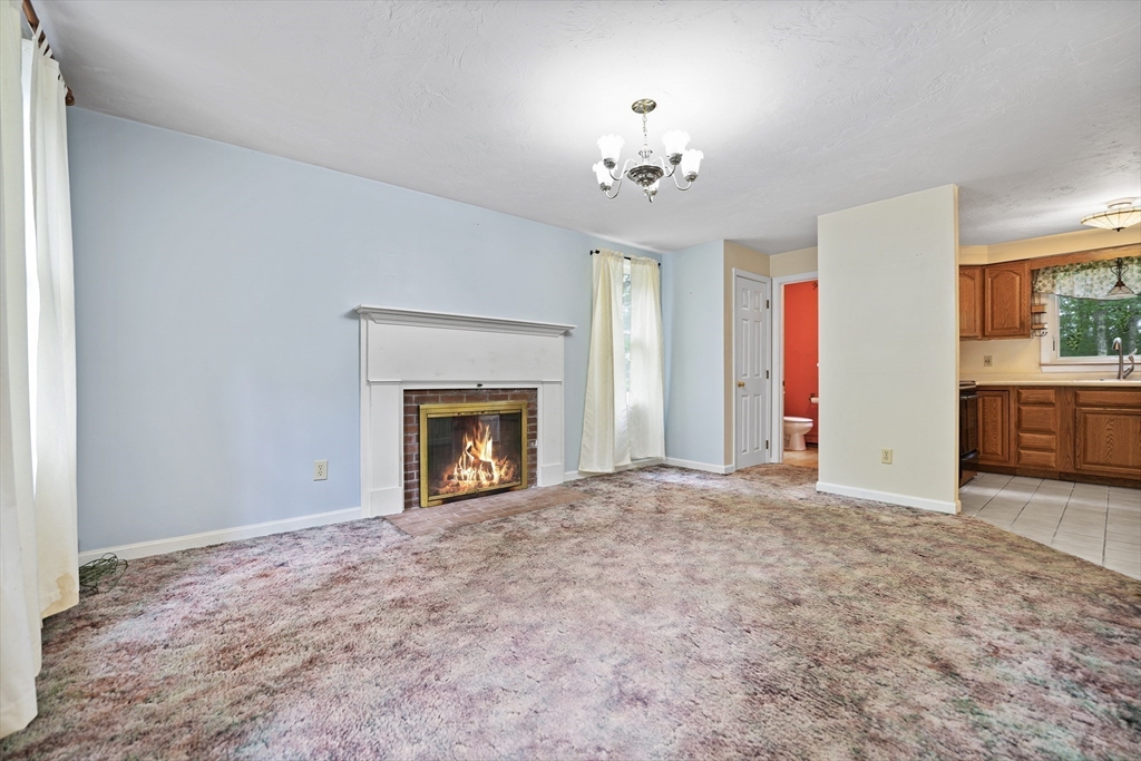 24 Springwood Drive Rochester, MA 02770 - Photo 5 of 21 a view of an empty room with a fireplace
