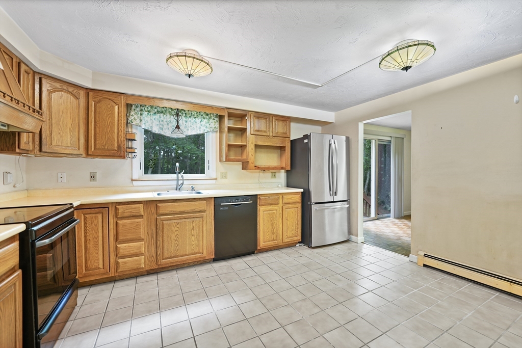 24 Springwood Drive Rochester, MA 02770 - Photo 7 of 21 a kitchen with stainless steel appliances granite countertop a stove a sink dishwasher and a refrigerator