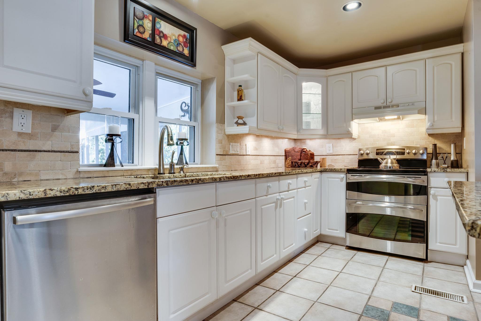 4133 Arno Road Franklin, TN 37064 - Photo 14 of 30 a kitchen with granite countertop a stove sink and cabinets
