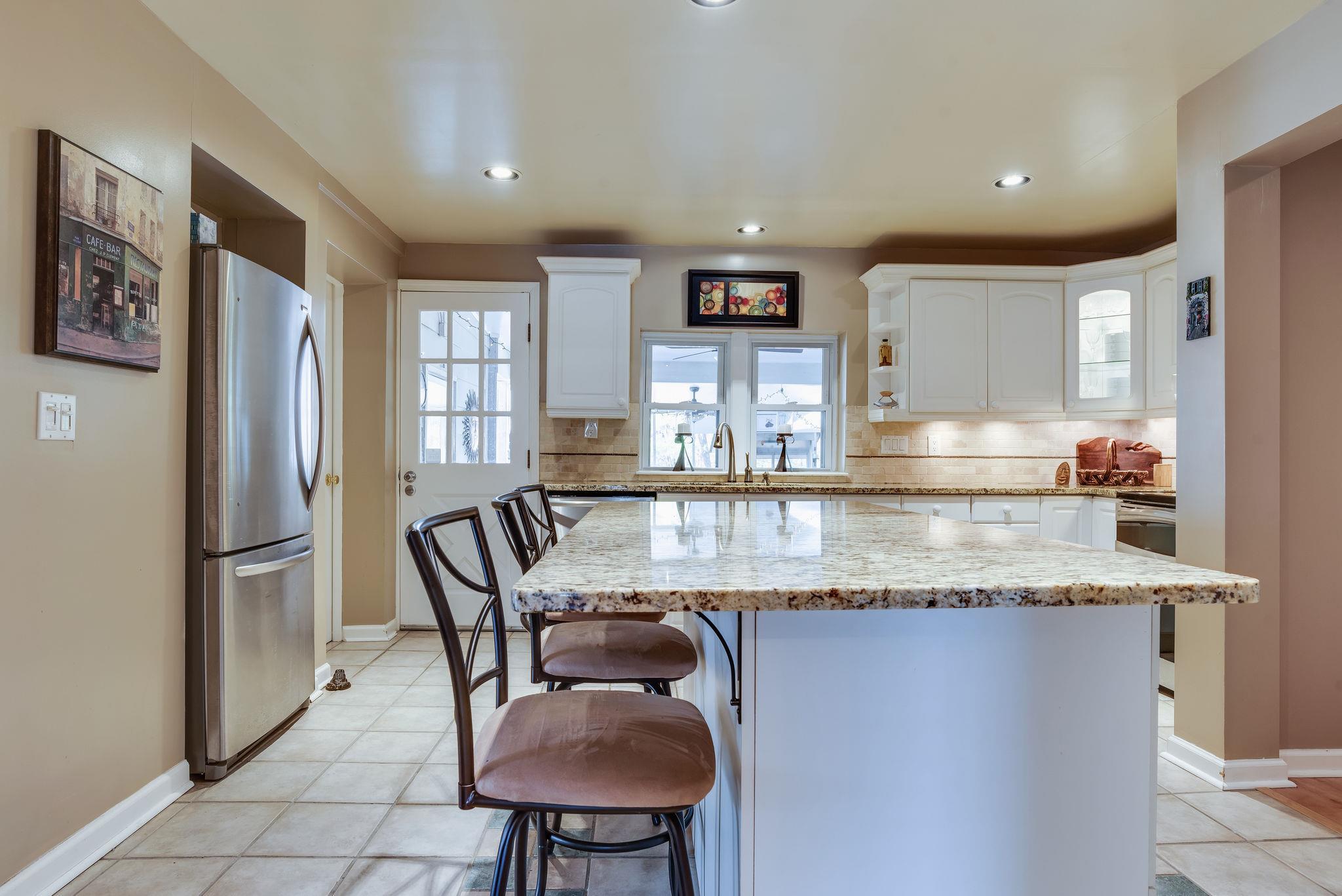 4133 Arno Road Franklin, TN 37064 - Photo 16 of 30 a kitchen with stainless steel appliances granite countertop a table chairs sink and refrigerator