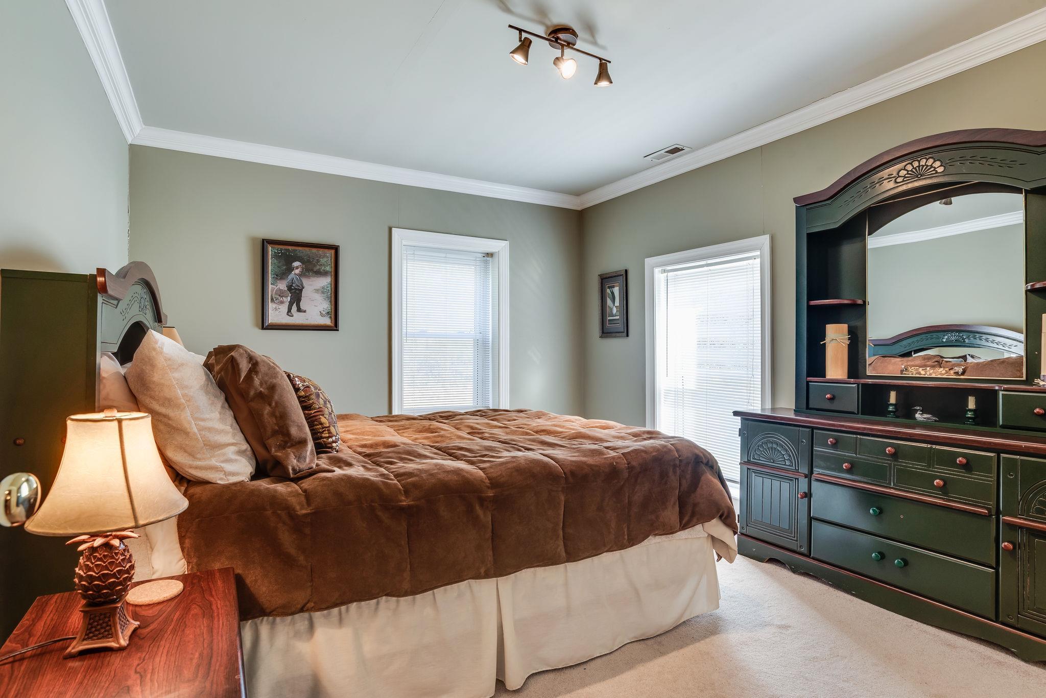 4133 Arno Road Franklin, TN 37064 - Photo 17 of 30 a bedroom with a bed and dresser with mirror