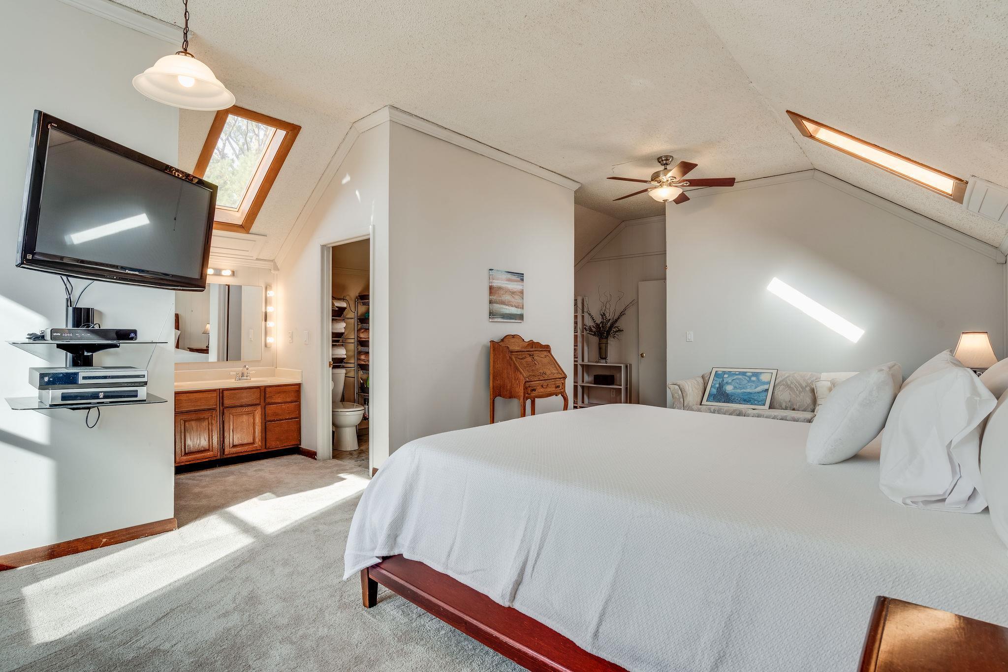 4133 Arno Road Franklin, TN 37064 - Photo 23 of 30 a bedroom with a bed a flat screen tv and a chandelier