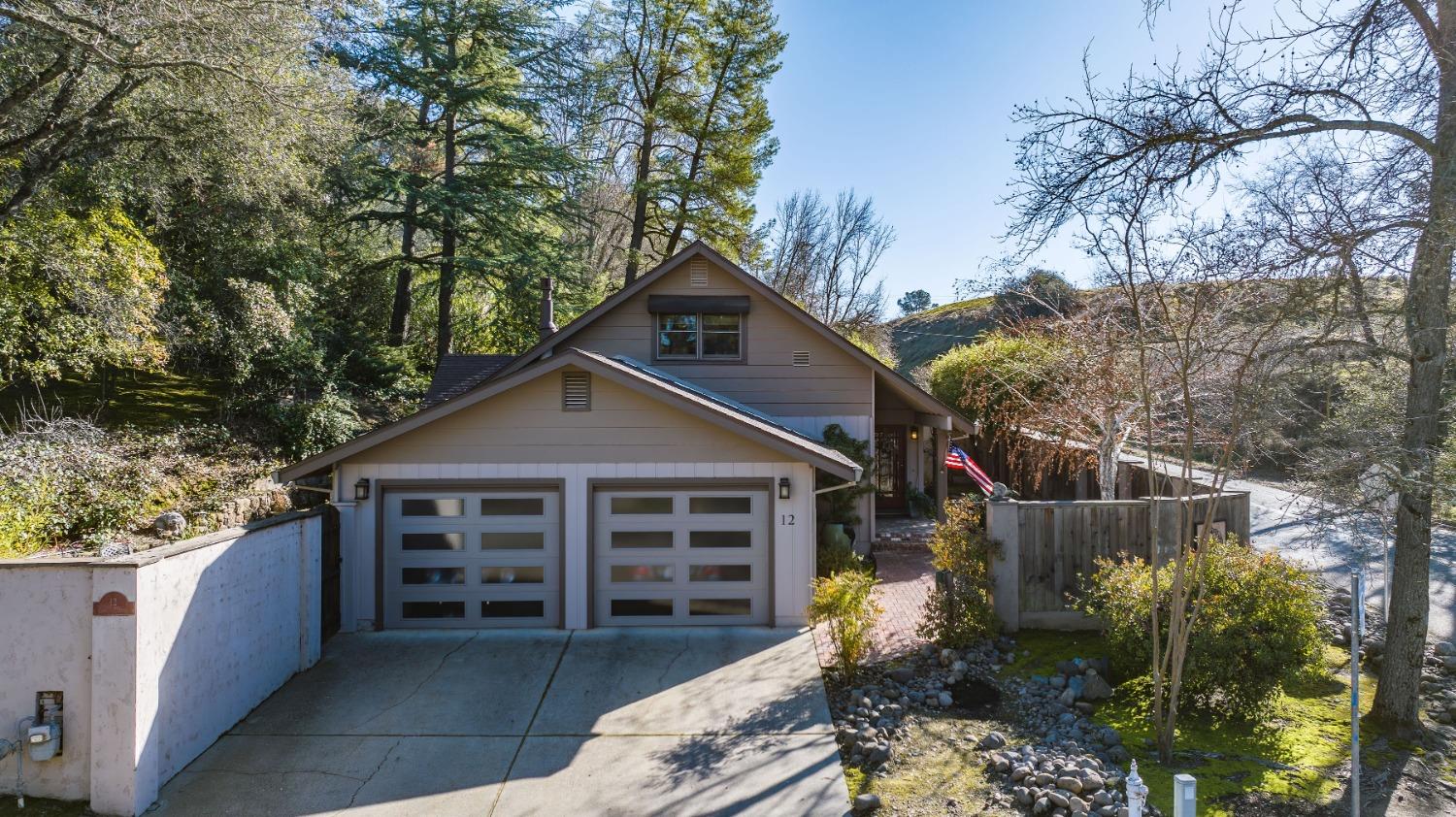 a view of a house with a yard and wooden fence