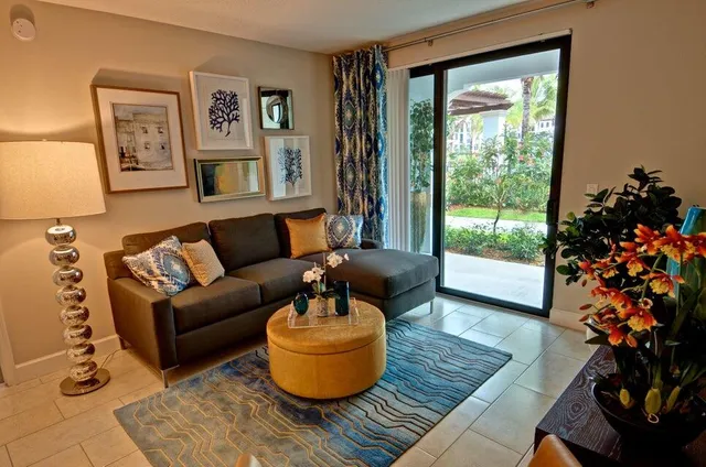 a living room with furniture and a potted plant