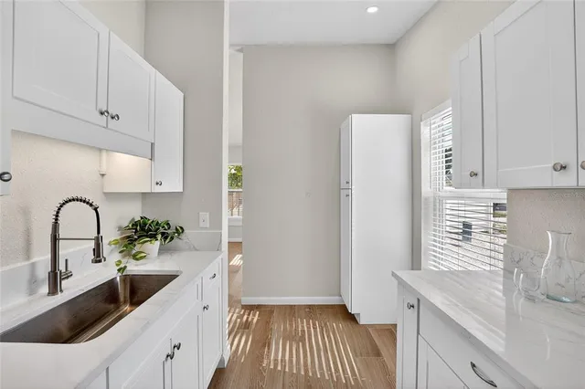 a kitchen with sink and cabinets