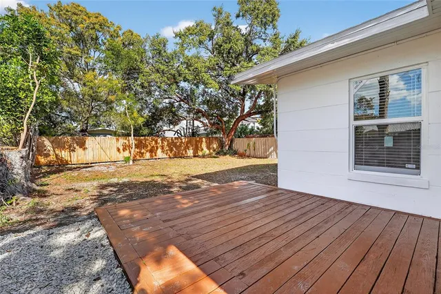 a view of a yard with wooden fence