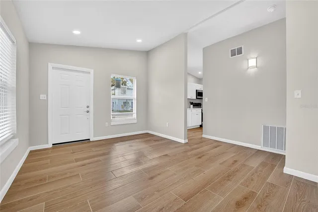 wooden floor in an empty room with a window