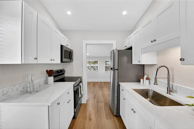 a kitchen with a sink cabinets and stainless steel appliances