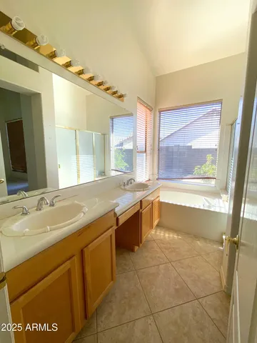 a large bathroom with a large tub sink and vanity