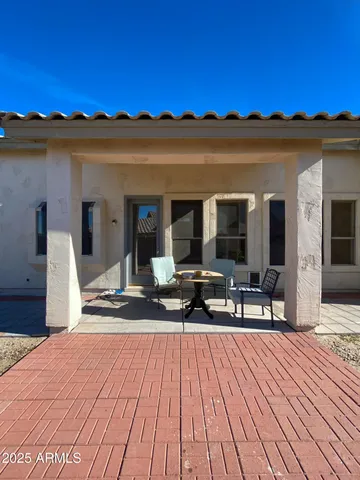 a view of a balcony with two chairs and a potted plant