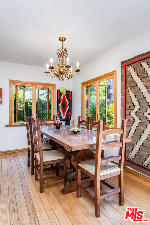 454 East Rustic Road Santa Monica, CA 90402 - Photo 14 of 34 a view of a dining room with furniture a chandelier and wooden floor