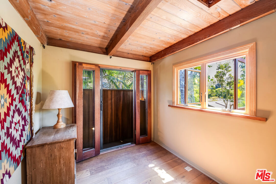 454 East Rustic Road Santa Monica, CA 90402 - Photo 22 of 34 a view of an empty room with wooden floor and a window