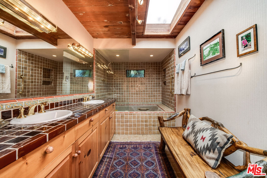 454 East Rustic Road Santa Monica, CA 90402 - Photo 29 of 34 a bathroom with a sink a toilet a mirror and shower