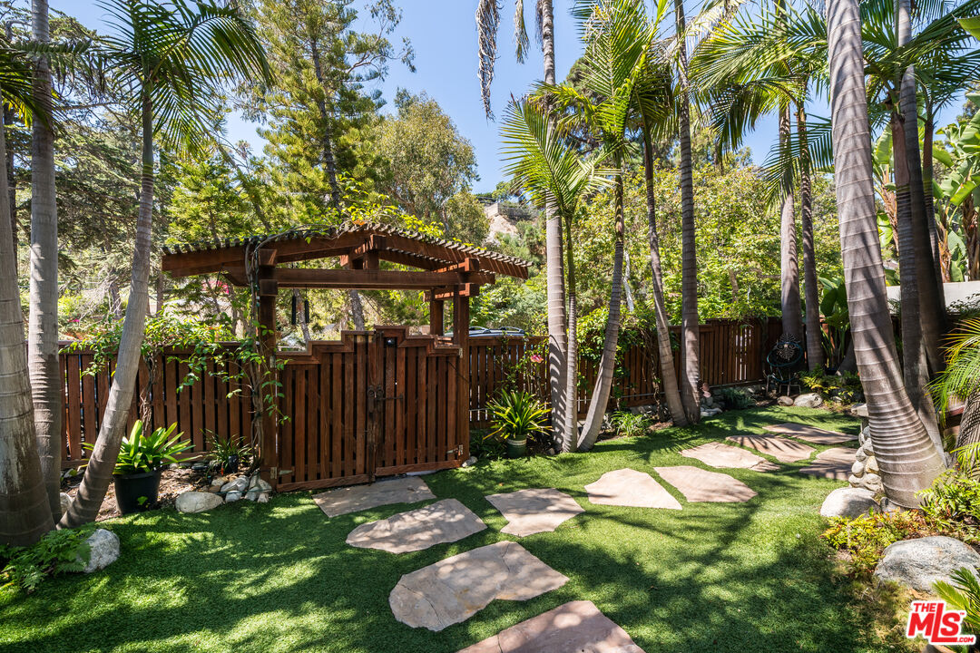 454 East Rustic Road Santa Monica, CA 90402 - Photo 3 of 34 a view of backyard with a barn and a large tree