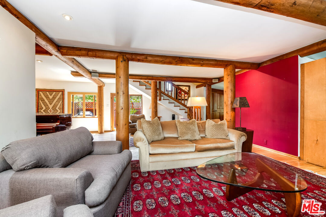 454 East Rustic Road Santa Monica, CA 90402 - Photo 10 of 34 a living room with furniture a rug and a floor to ceiling window