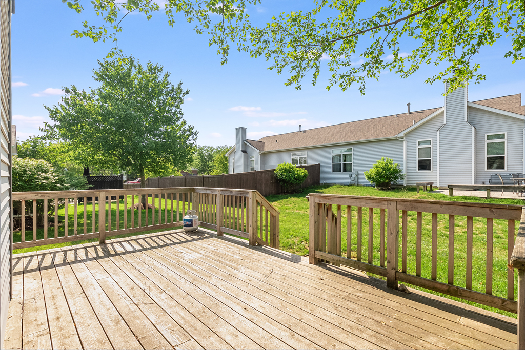 611 Chestnut Drive Oswego, IL 60543 - Photo 13 of 15 a balcony with wooden floor and fence