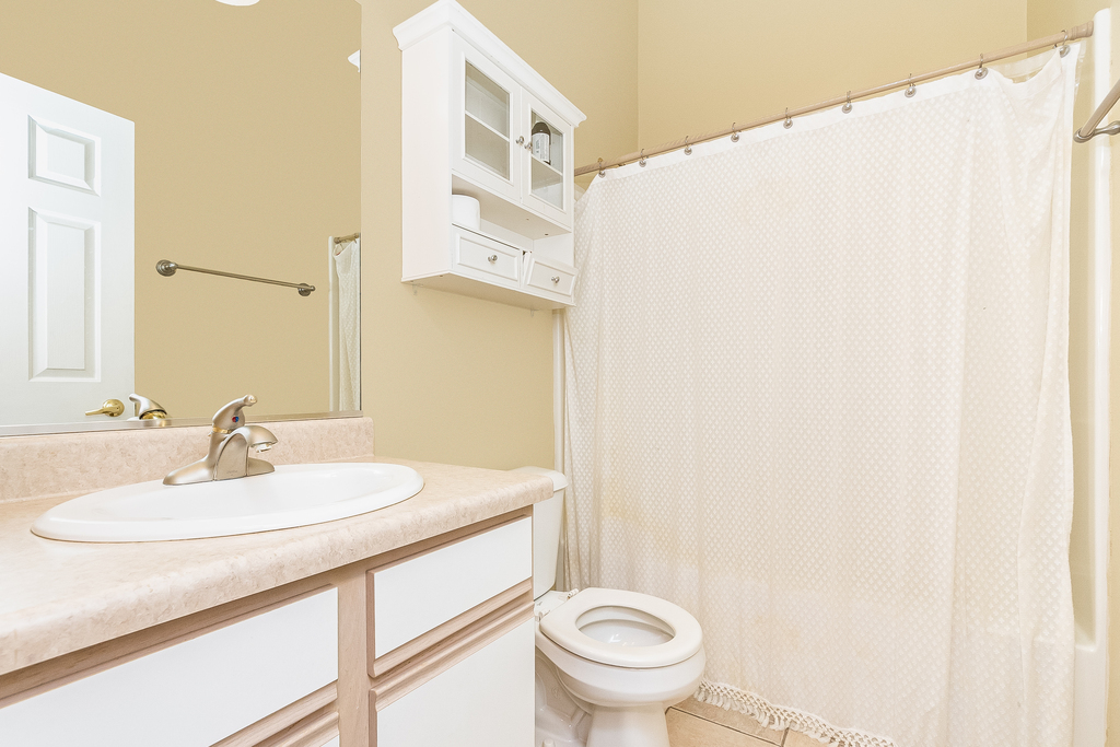 611 Chestnut Drive Oswego, IL 60543 - Photo 6 of 15 a bathroom with a sink a toilet and a mirror
