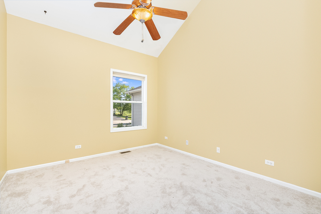611 Chestnut Drive Oswego, IL 60543 - Photo 7 of 15 a view of a big room with windows and ceiling fan