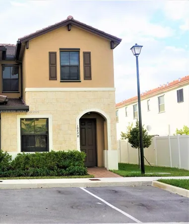 a front view of a house with yard and garage