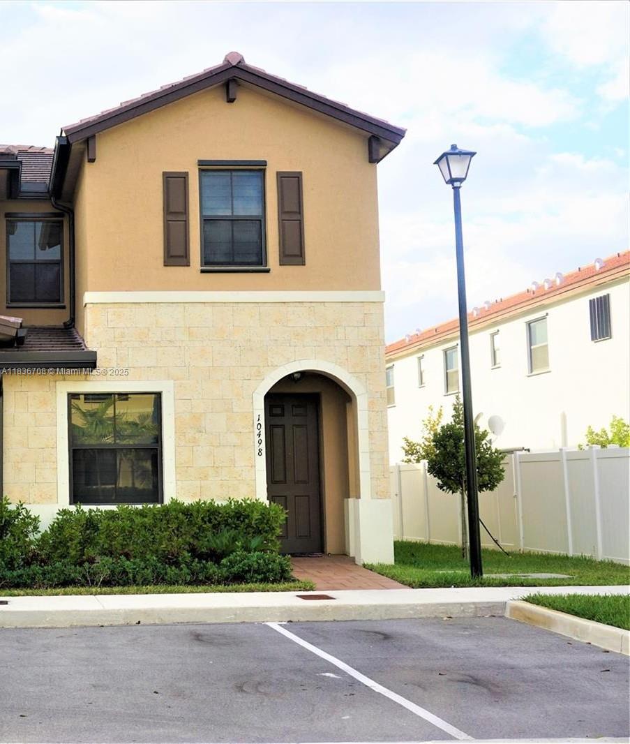 a front view of a house with yard and garage