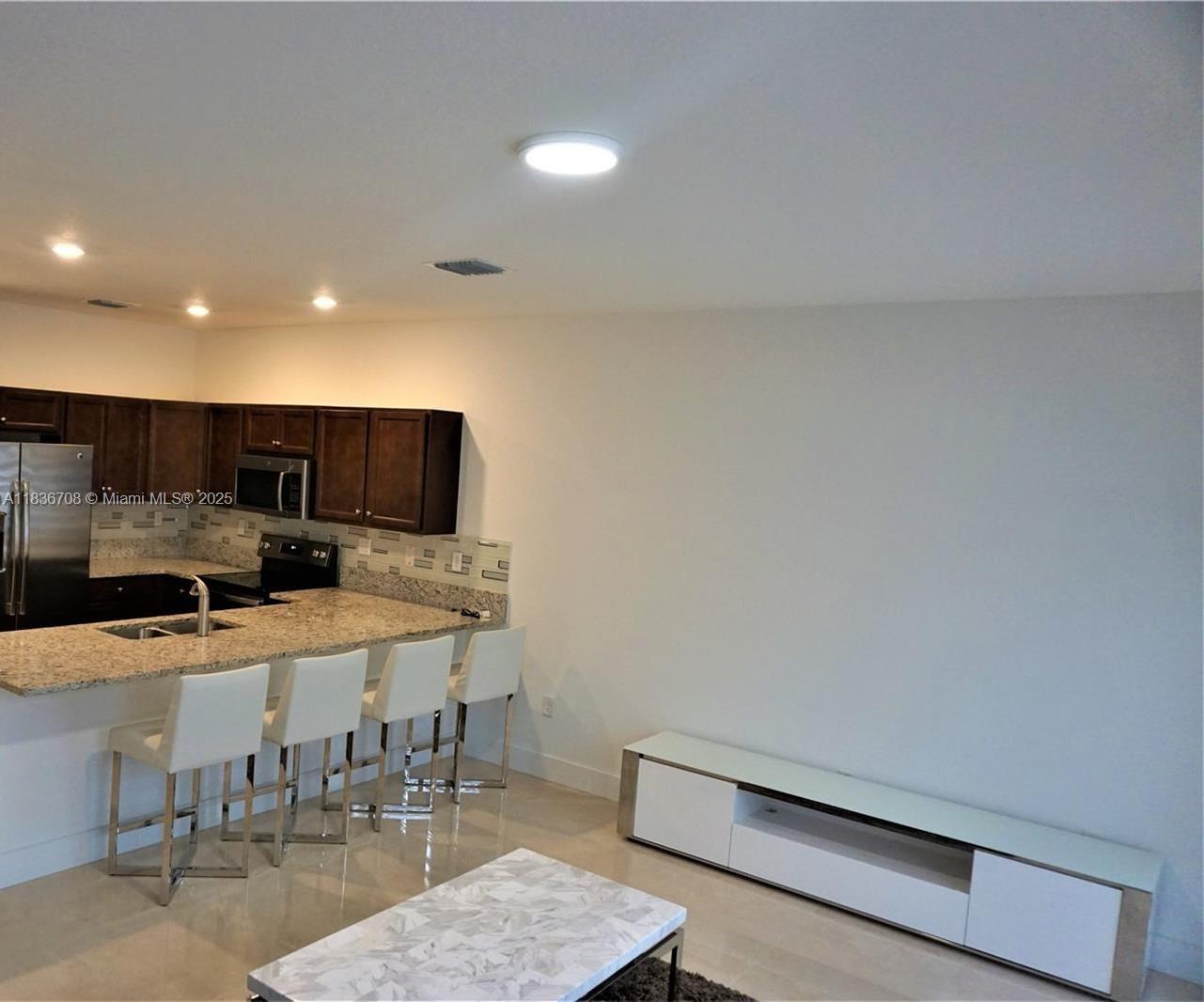 10498 West 33rd Way Hialeah, FL 33018 - Photo 12 of 28 a view of a dining room with furniture