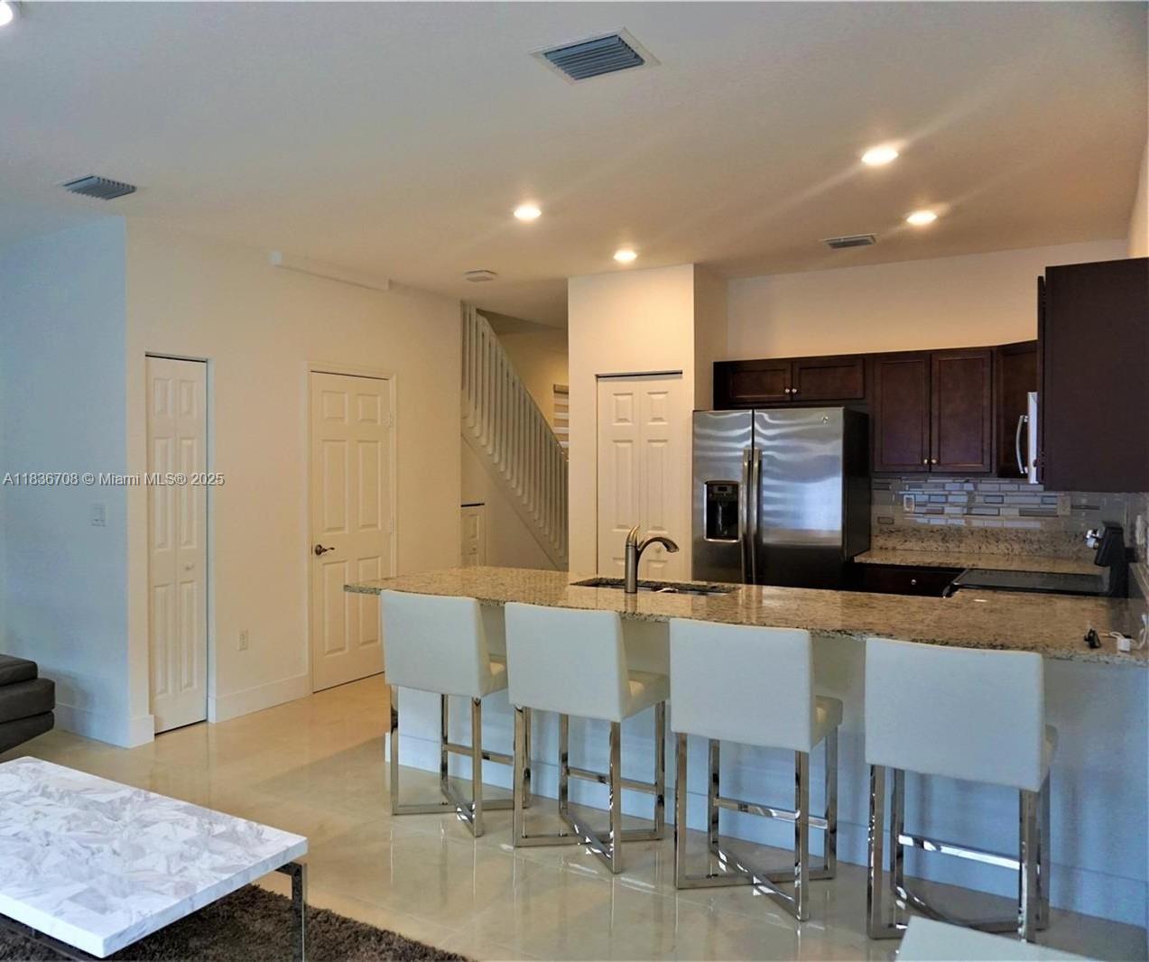 10498 West 33rd Way Hialeah, FL 33018 - Photo 13 of 28 a large kitchen with a table and chairs