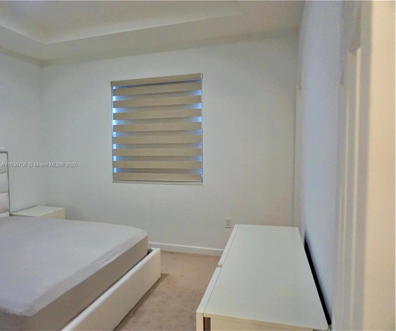 10498 West 33rd Way Hialeah, FL 33018 - Photo 17 of 28 a bedroom with a bed and a window