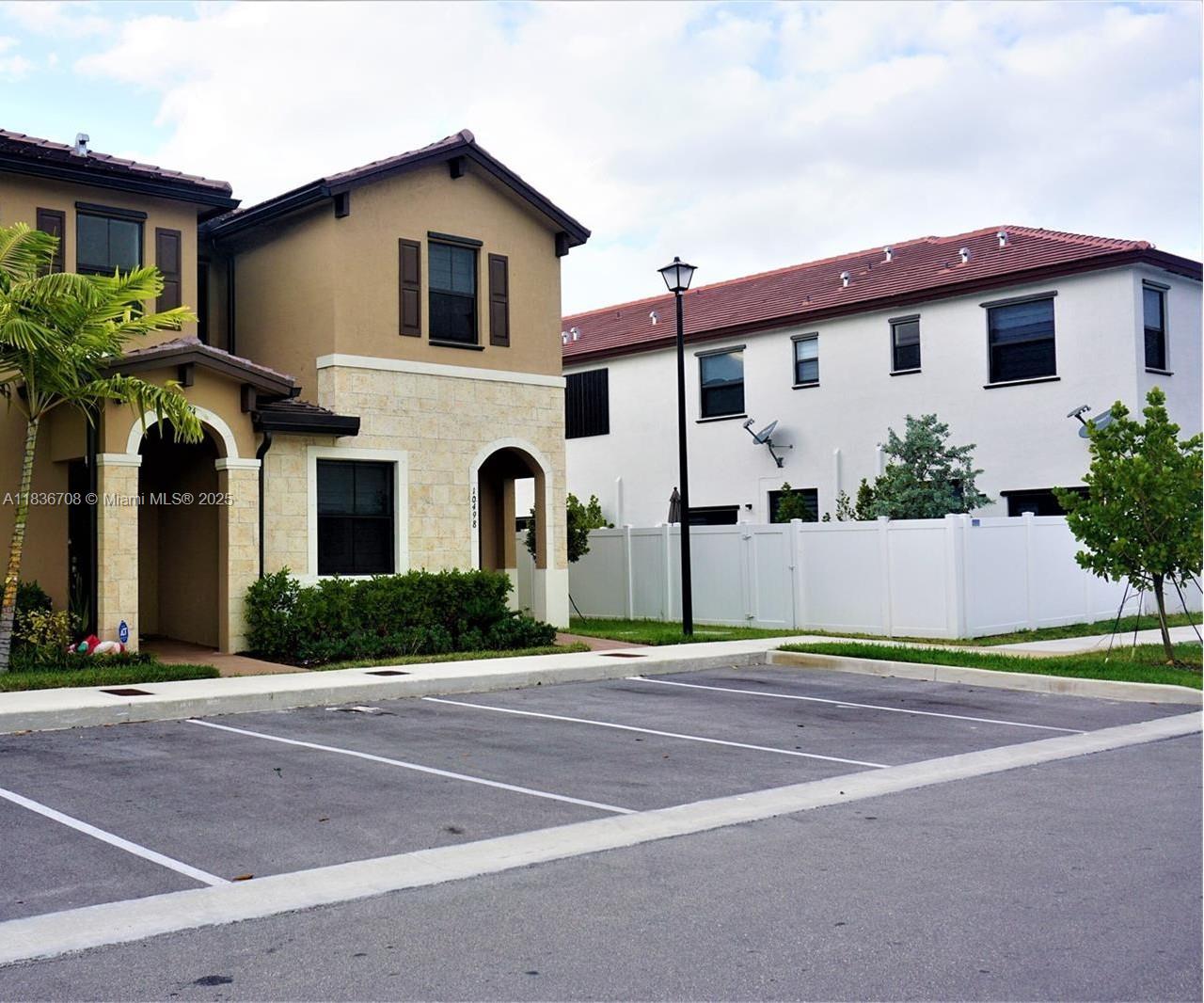 10498 West 33rd Way Hialeah, FL 33018 - Photo 2 of 28 a front view of a house with a yard and garage