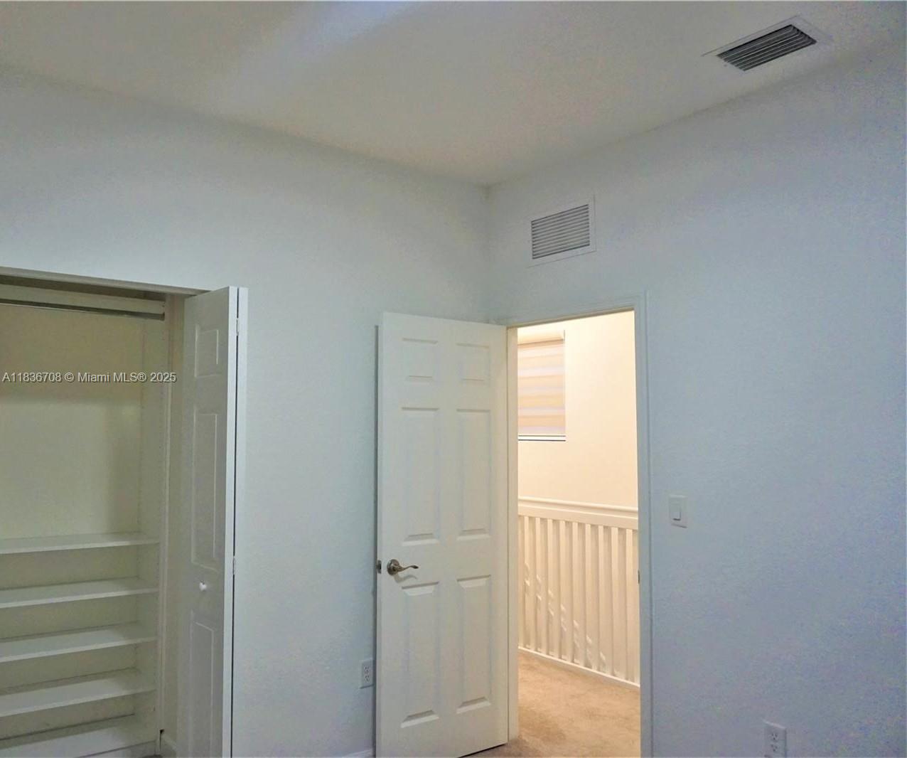 10498 West 33rd Way Hialeah, FL 33018 - Photo 21 of 28 a view of a hallway with wooden floor and closet
