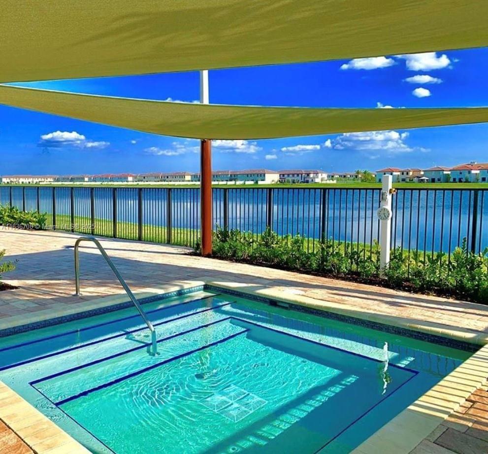 10498 West 33rd Way Hialeah, FL 33018 - Photo 28 of 28 a view of swimming pool with a table and chairs in front of it