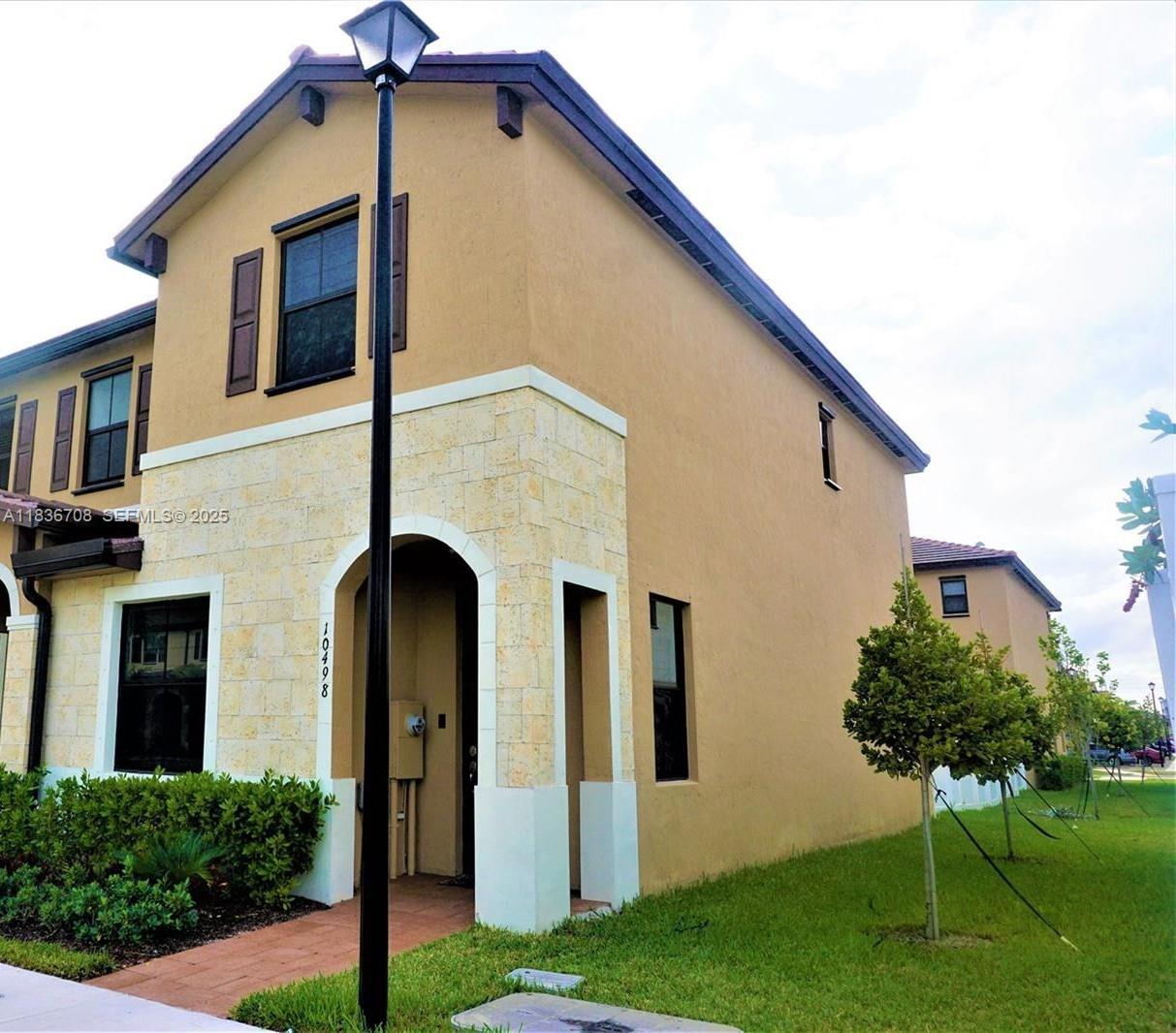 10498 West 33rd Way Hialeah, FL 33018 - Photo 3 of 28 a front view of a house with garden
