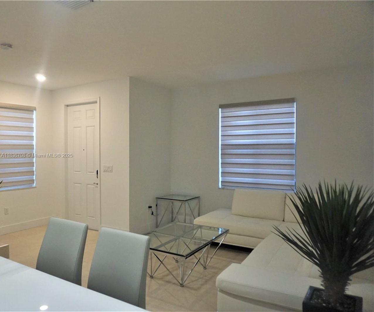 10498 West 33rd Way Hialeah, FL 33018 - Photo 5 of 28 a living room with furniture and a potted plant