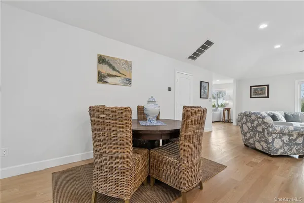 a dining room with furniture and wooden floor