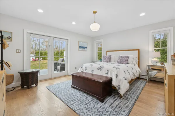 a bed sitting in a spacious bedroom next to a window