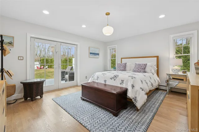 a bed sitting in a spacious bedroom next to a window
