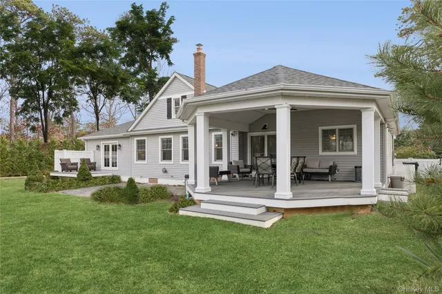 a front view of a house with a garden and plants