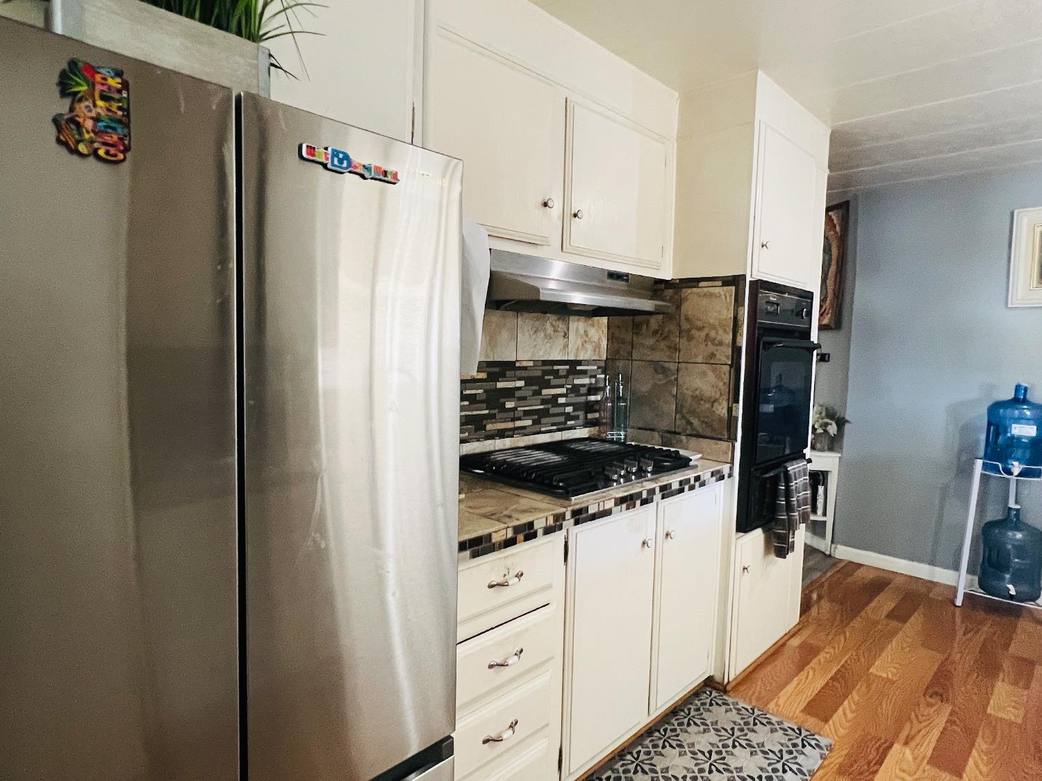 2845 East E Hatch Road, Unit 86 Ceres, CA 95351 - Photo 14 of 32 a kitchen with white cabinets and appliances