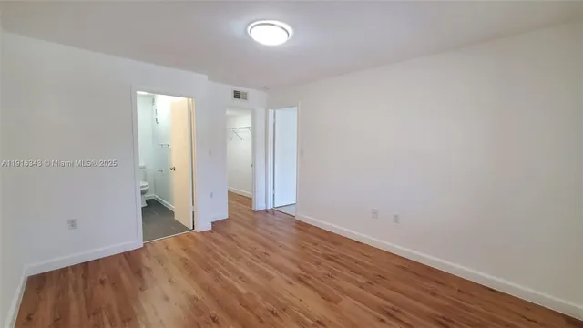 a view of a room with wooden floor