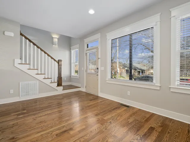 a view of an entryway with wooden floor and windows