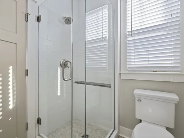 a bathroom with a toilet and shower