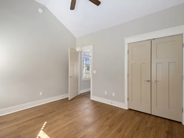 a view of an empty room with wooden floor