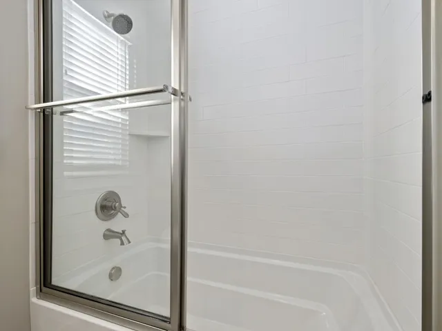 a bathroom with a glass shower door